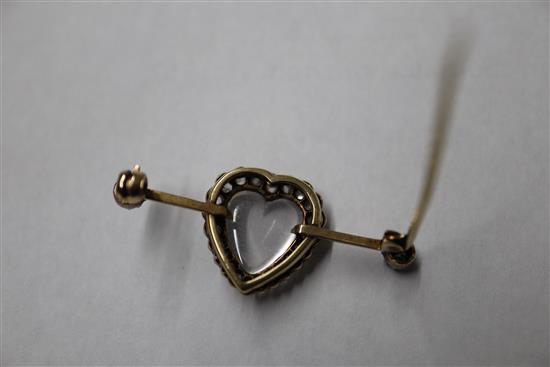 A diamond and moonstone bar brooch, heart-shaped setting in yellow metal (one stone missing), boxed 40mm.